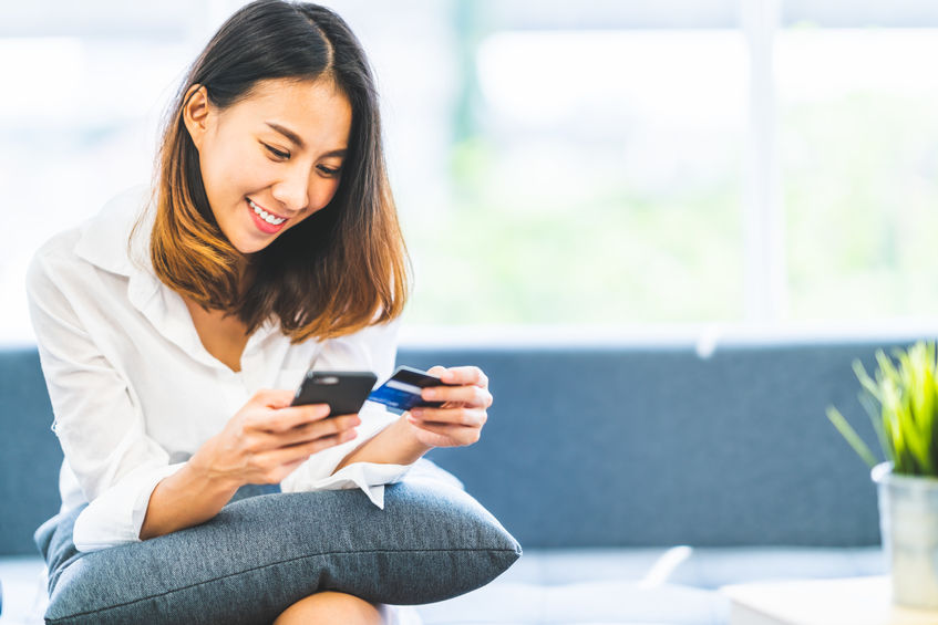 woman making online payment on her phone