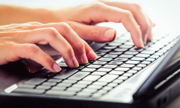 woman typing on keyboard