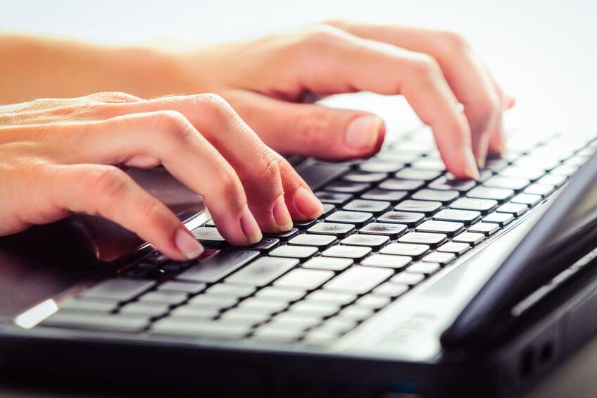 woman typing on keyboard