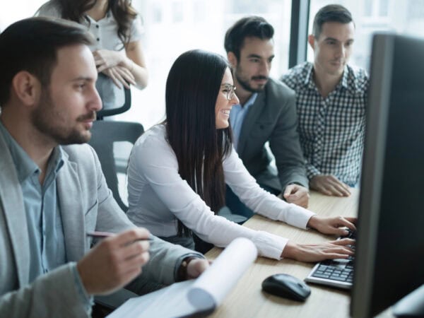 Software engineers working in office on project together