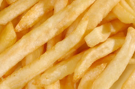 Close-up of a pile of golden, crispy French fries.